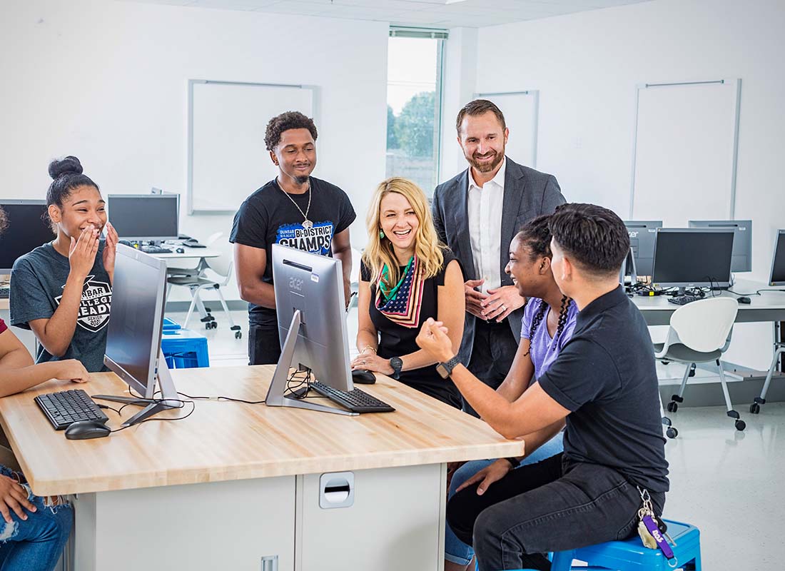 teacher and class around computer