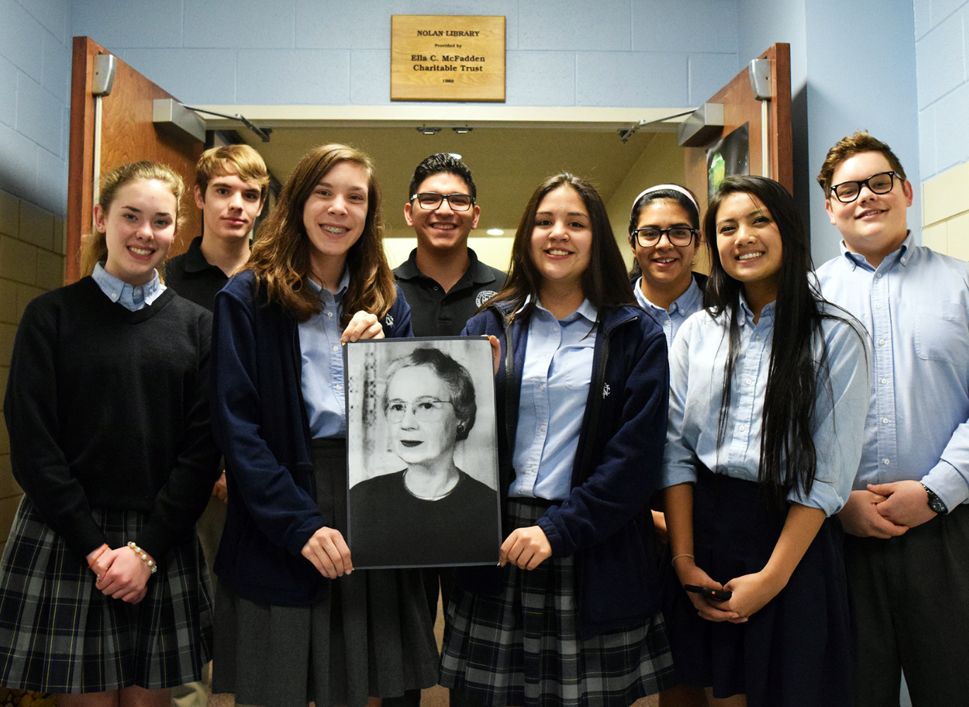 Students holding Ella McFadden's portrait