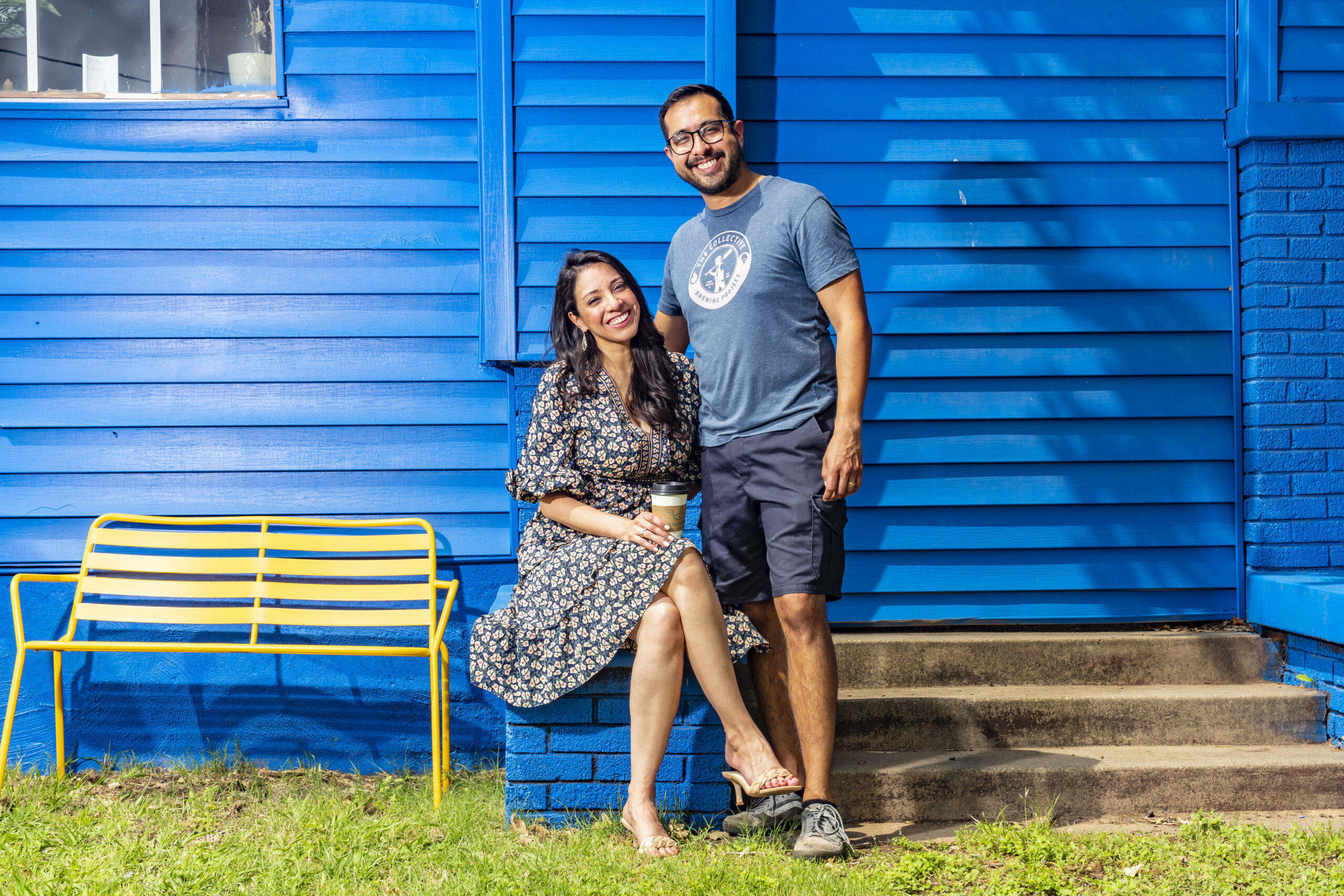 Photo of a man and a woman in front of a blue house.