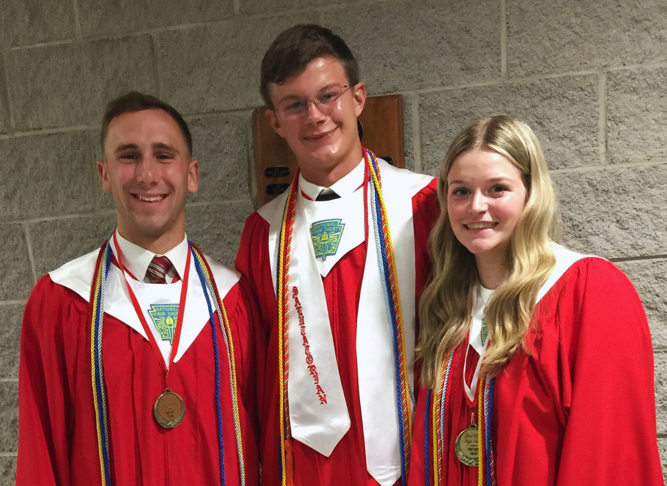 Photo of three high school graduates