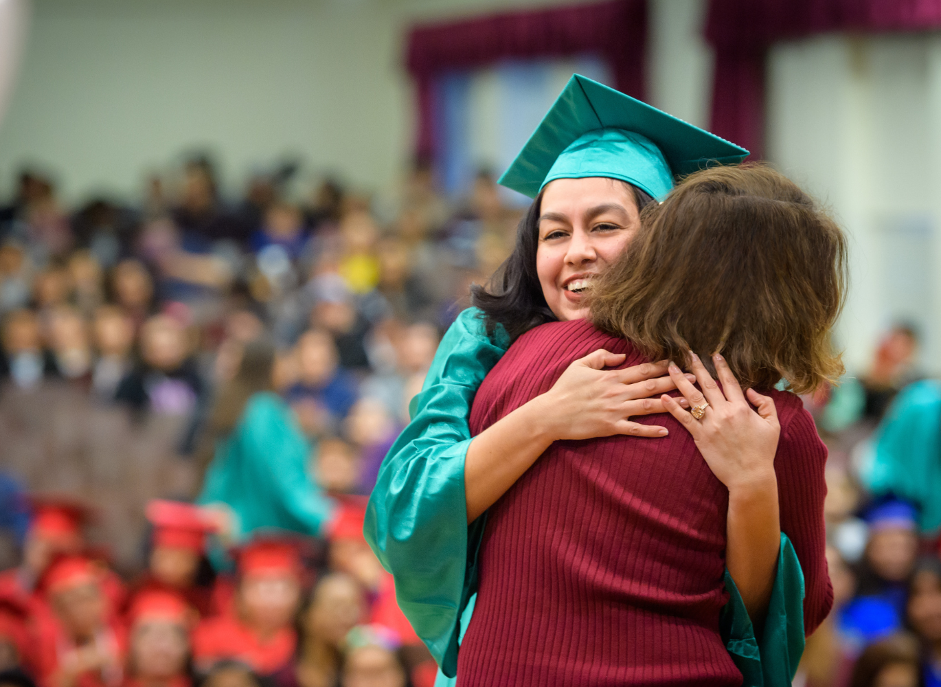 Photo of a graduate embracing a women