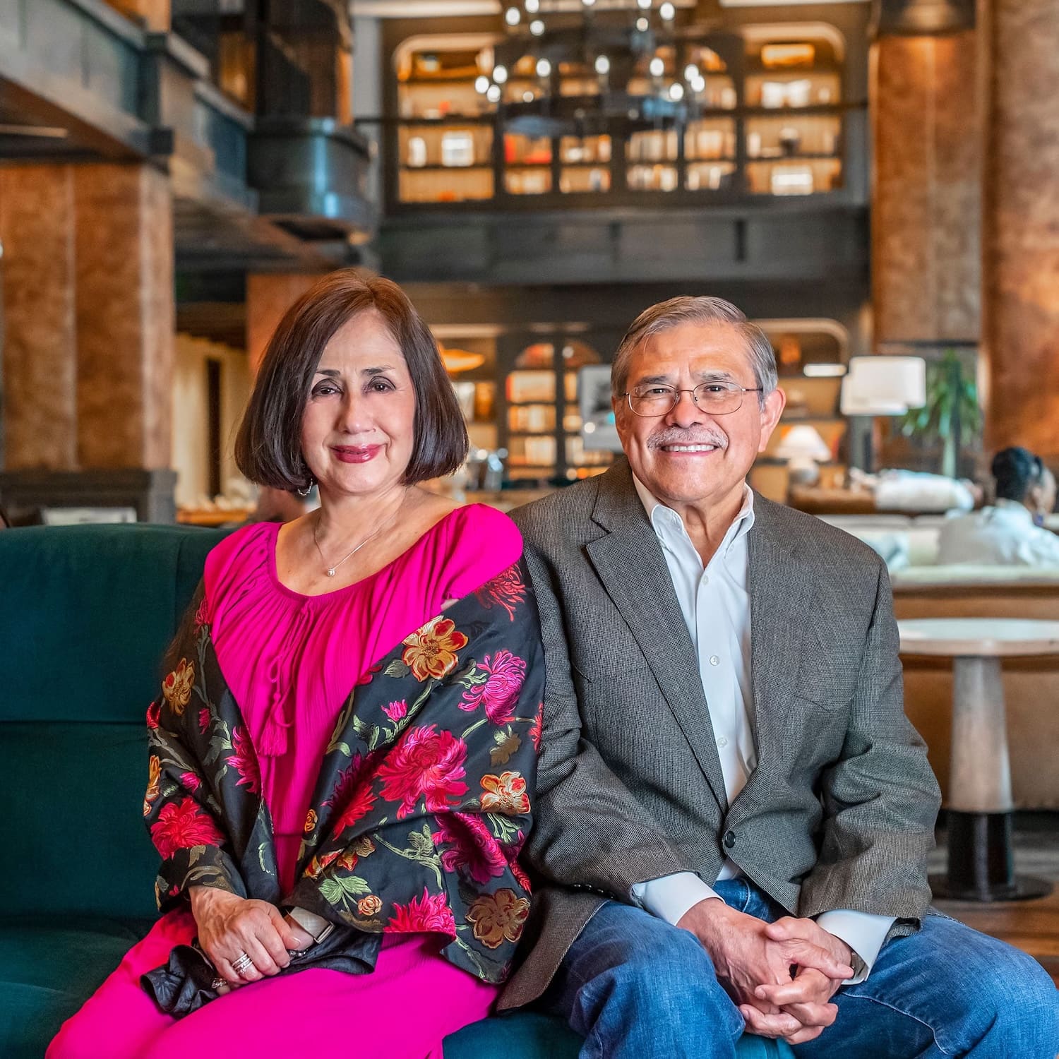 Photo of man and woman sitting on a blue couch